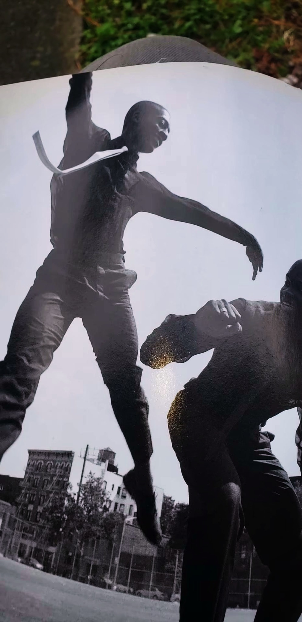 Magazine spread showing a dancer leaping over a Harlem basketball court