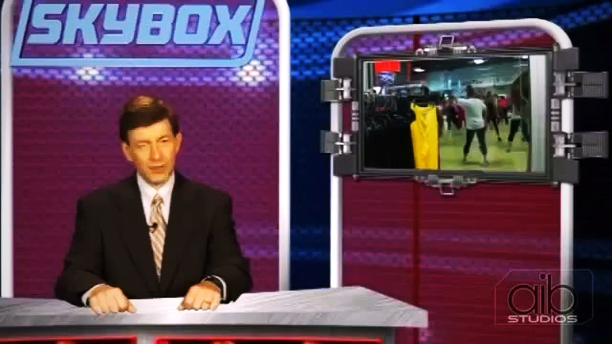 SKYBOX television sports-desk segment featuring dance footage on the studio monitor
