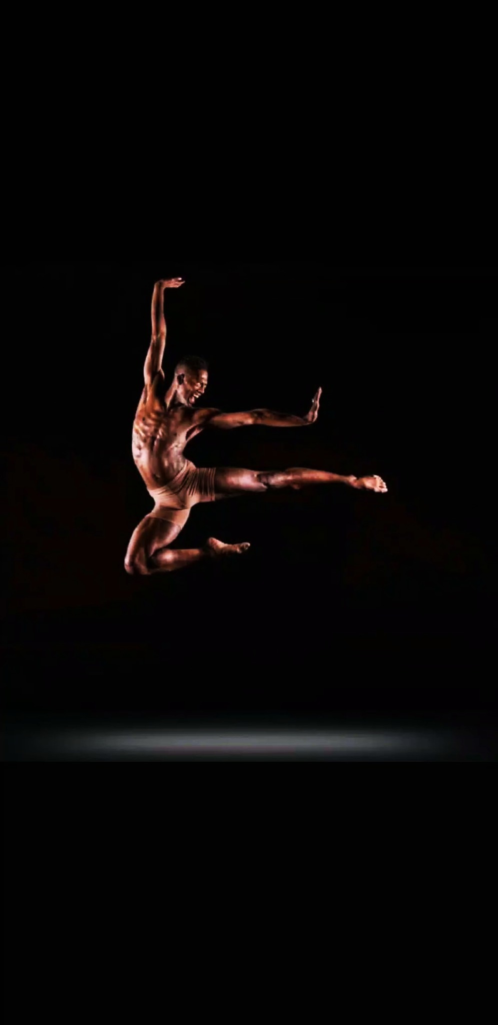 RikkiTheFool suspended mid-leap against a black background