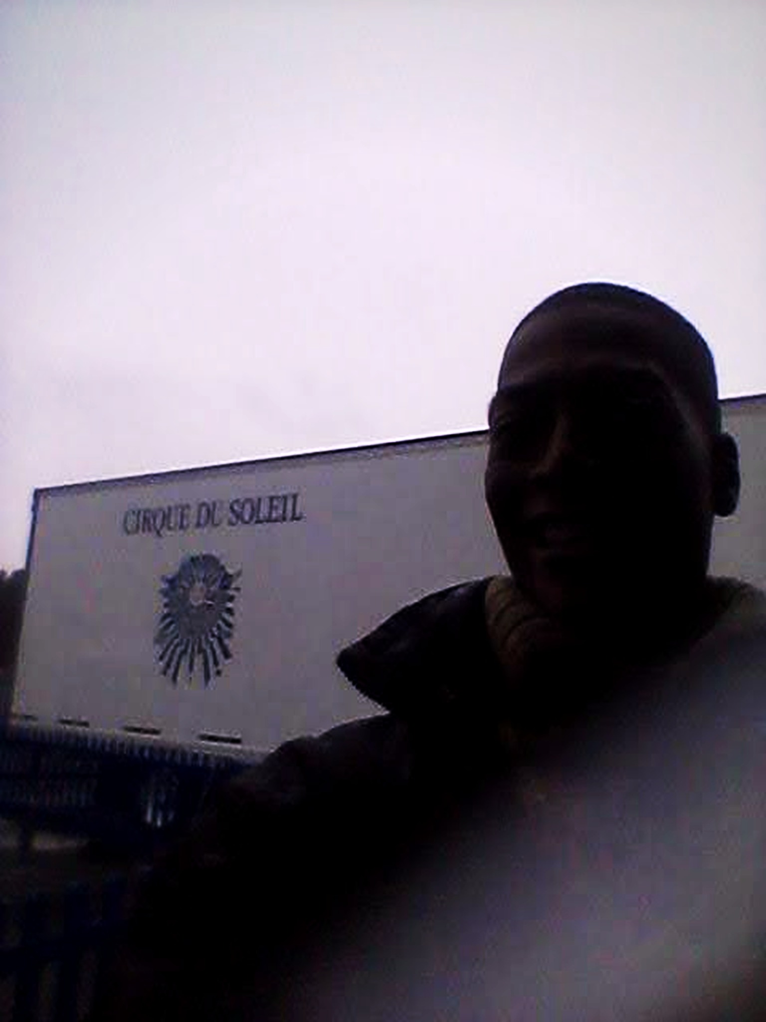 RikkiTheFool posing in front of a Cirque du Soleil trailer