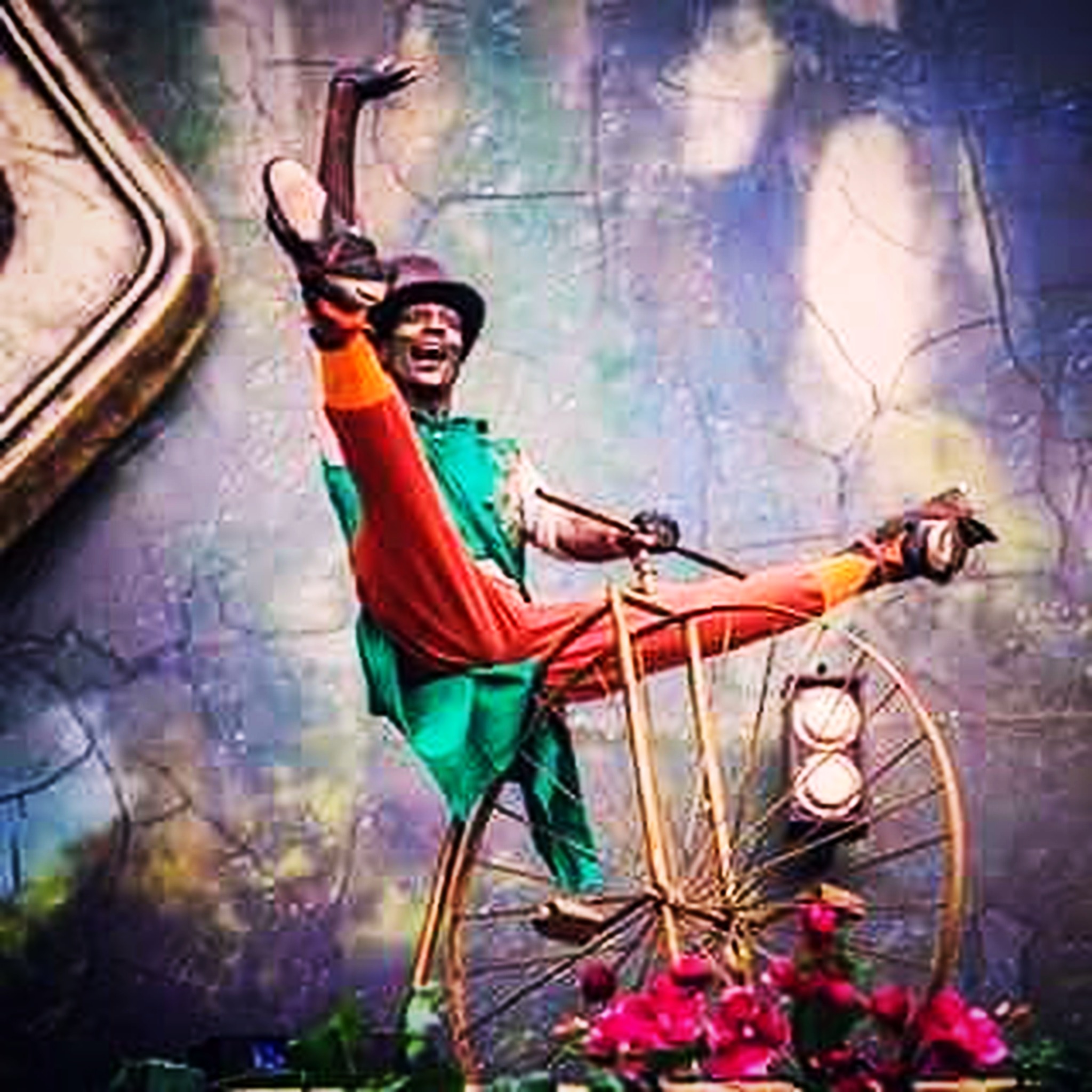 RikkiTheFool performing in colorful costume on a penny-farthing bicycle